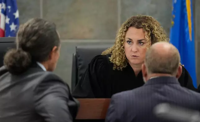 Clark District Court Judge Carli Kierny, center, speaks with defense attorney Michael Sanft, left, and Chief Deputy District Attorney Marc DiGiacomo during the murder trial of Duane "Keffe D" Davis related to the 1996 killing of rapper Tupac Shakur, at Clark County District Court Regional Justice Center in Las Vegas, on Tuesday, Aug. 18, 2026. (AP Photo/John Locher, Pool)