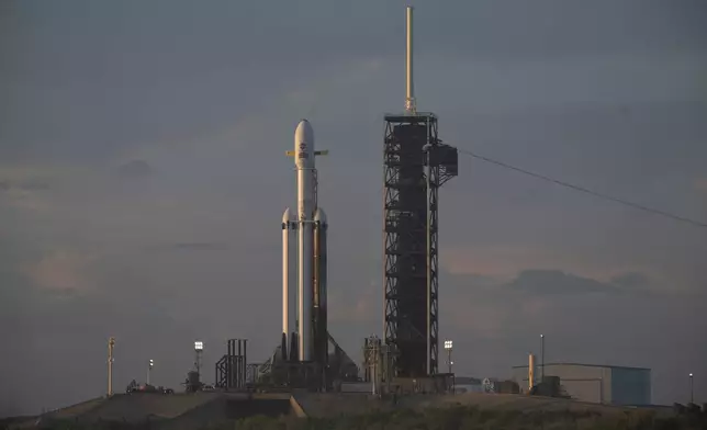 NASA's Nancy Grace Roman Space Telescope, encapsulated in a protective payload fairing atop a SpaceX Falcon Heavy rocket, is seen at sunrise, Saturday, Aug. 29, 2026, at Launch Complex 39A at NASA's Kennedy Space Center in Florida. (Joel Kowsky/NASA via AP)