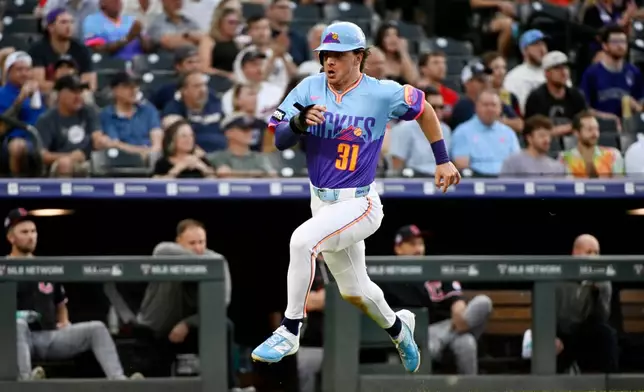 Colorado Rockies' Jake McCarthy runs to score on an RBI single hit by Willi Castro in the first inning of a baseball game against the Cleveland Guardians, Friday, Aug. 21, 2026, in Denver. (AP Photo/Geneva Heffernan)