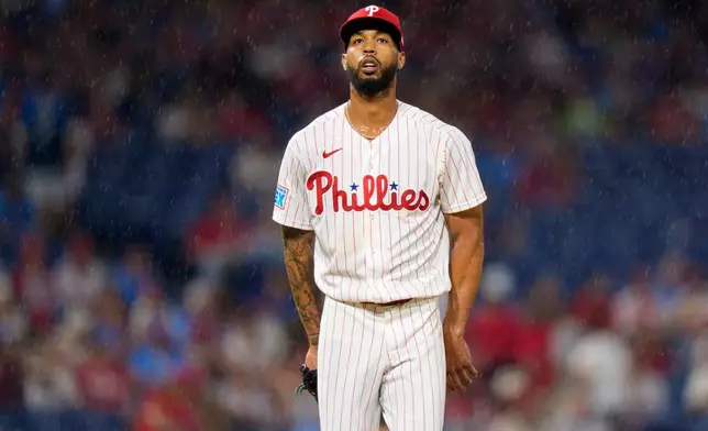 Philadelphia Phillies starting pitcher Cristopher Sanchez looks on as rain falls during the sixth inning of a baseball game against the Miami Marlins, Monday, Aug. 17, 2026, in Philadelphia. (AP Photo/Chris Szagola)