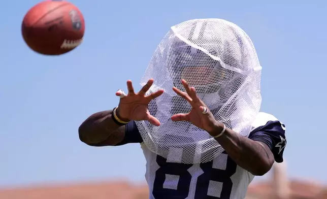 Dallas Cowboys wide receiver Ceedee Lamb catches passes from a machine during the NFL football team's training camp, Monday, Aug. 3, 2026, in Oxnard, Calif. (AP Photo/Mark J. Terrill)