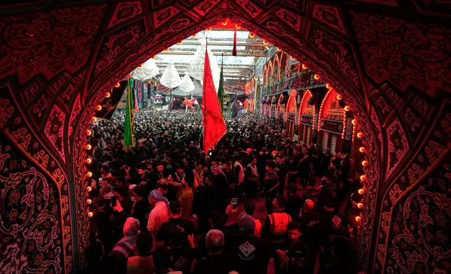 Shiite pilgrims perform mourning rituals during Arbaeen at the Imam Hussein Shrine in Karbala, Iraq, Tuesday, Aug. 4, 2026. (AP Photo/Hadi Mizban)