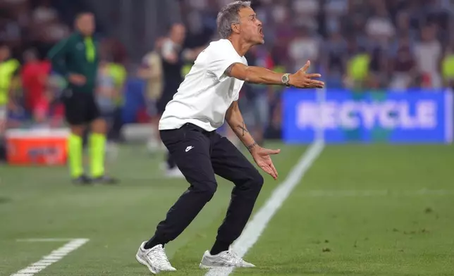 PSG's head coach Luis Enrique instructs his players during the UEFA Super Cup soccer match between Paris Saint-Germain and Aston Villa in Salzburg, Austria, Wednesday, Aug. 12, 2026. (AP Photo/Heinz-Peter Bader)