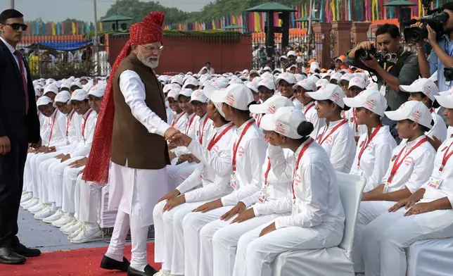 Indian Prime Minister Narendra Modi greets children after addressing the nation from the rampart of the Red Fort monument during the country's Independence Day celebrations in New Delhi, India, Saturday, Aug. 15, 2026. (AP Photo/Sanjeev Rastogi)