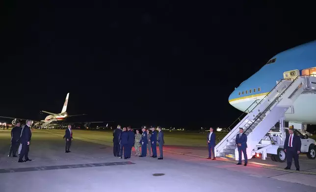 President Donald Trump talks to service members as he switches planes at U.S. Air Force Base, RAF Mildenhall in Suffolk Eastern England, on his way back to Washington from the NATO summit in Ankara, Turkey, Wednesday, July 8, 2026. (AP Photo/Alex Brandon)