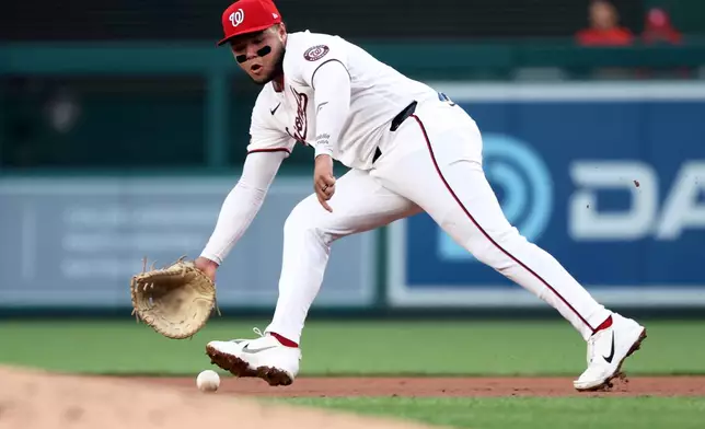 Washington Nationals first baseman Abimelec Ortiz makes a catch during the second inning of a baseball game against the Colorado Rockies, Tuesday, Aug. 25, 2026, in Washington. (AP Photo/Daniel Kucin Jr.)