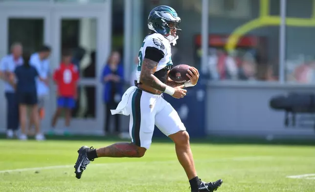 Philadelphia Eagles running back Ja'Quinden Jackson runs with the ball during a joint NFL football practice with the New England Patriots, Wednesday, Aug. 19, 2026, in Foxborough, Mass. (AP Photo/Steven Senne)
