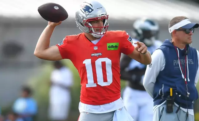 New England Patriots quarterback Drake Maye (10) winds up to pass during a joint NFL football practice with the Philadelphia Eagles, Wednesday, Aug. 19, 2026, in Foxborough, Mass. (AP Photo/Steven Senne)