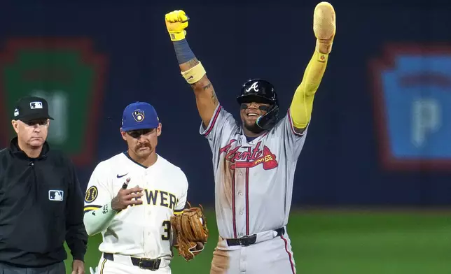 Atlanta Braves' Ronald Acuña Jr., right, celebrates next to Milwaukee Brewers shortstop Joey Ortiz (3) after stealing second base during the fifth inning of the Little League Classic baseball game in Williamsport, Pa., Sunday, Aug. 23, 2026. (AP Photo/Gene J. Puskar)