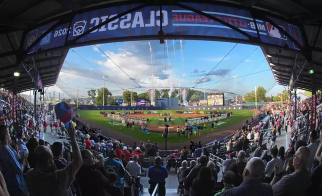 In this photo taken with a fisheye lens, fans fill the ballpark for the opening ceremony before the Little League Classic baseball game between the Milwaukee Brewers and the Atlanta Braves at Bowman Field in Williamsport, Pa., Sunday, Aug. 23, 2026. (AP Photo/Gene J. Puskar)