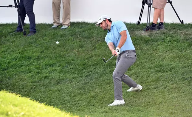 Patrick Cantlay chips onto the 18th green during the first round of the Rocket Classic golf tournament at the Detroit Golf Club, Thursday, July 30, 2026, in Detroit. (AP Photo/Jose Juarez)