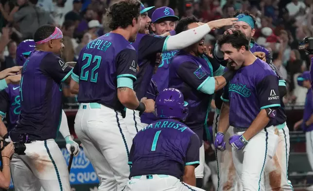 Arizona Diamondbacks' Ryan Waldschmidt celebrates with teammates after hitting a two-run walk off home run against the Los Angeles Dodgers during a baseball game, Friday, Aug 7, 2026, in Phoenix. (AP Photo/Rick Scuteri)