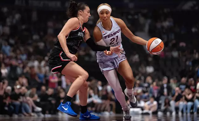 Portland Fire's Bridget Carleton (6) defends against Toronto Tempo's Isabelle Harrison (21) during the first half of a WNBA basketball game in Vancouver, British Columbia, Friday, Aug. 21, 2026. (Ethan Cairns/The Canadian Press via AP)
