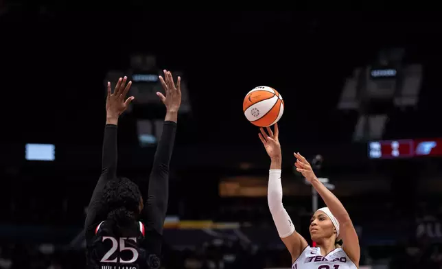 Toronto Tempo's Isabelle Harrison (21) shoots as Portland Fire's Serah Williams (25) defends during the first half of a WNBA basketball game in Vancouver, British Columbia, Friday, Aug. 21, 2026. (Ethan Cairns/The Canadian Press via AP)