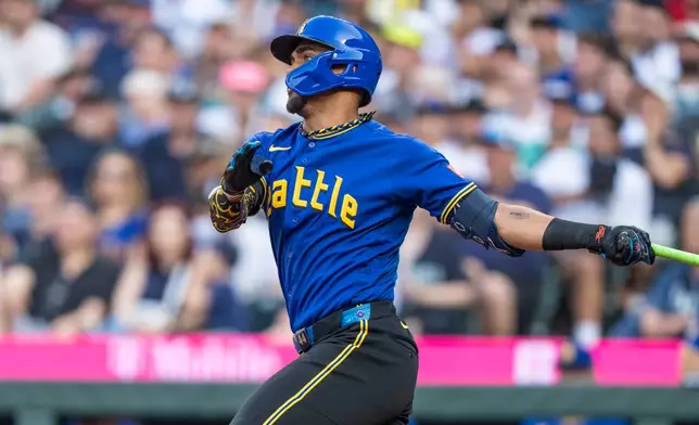 Seattle Mariners' Julio Rodriguez hits a single during the second inning of a baseball game against the Tampa Bay Rays, Friday, Aug. 7, 2026, in Seattle. (AP Photo/Stephen Brashear)