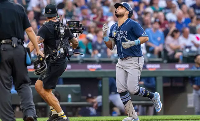 Tampa Bay Rays' Jonathan Aranda, right, rounds the bases after hitting a solo home run during the third inning of a baseball game against the Seattle Mariners, Friday, Aug. 7, 2026, in Seattle. (AP Photo/Stephen Brashear)