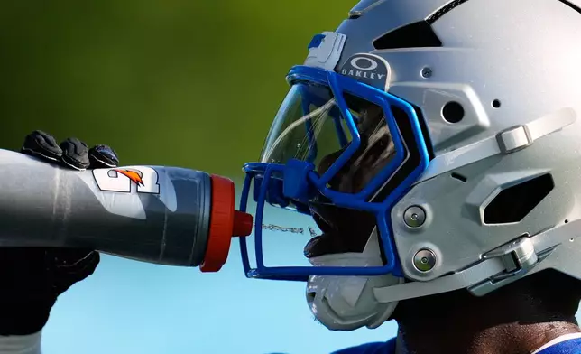 Detroit Lions running back Jabari Small drinks water to cool off from the heat during a NFL football training camp practice in Allen Park, Mich., Wednesday, July 29, 2026. (AP Photo/Paul Sancya)