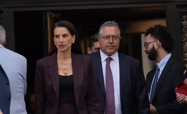 Defense attorneys for Luigi Mangione, Karen Friedman Agnifilo and Marc Agnifilo exit Manhattan federal court after Mangione pleaded guilty on to federal stalking charges in the killing of UnitedHealthcare CEO Brian Thompson, Friday, Aug. 14, 2026 in New York. (AP Photo/Ryan Murphy)