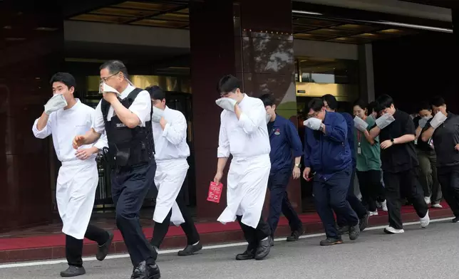 Staff members of a hotel take part in an anti-terror drill as a part of the Ulchi Freedom Shield military exercise between the U.S. and South Korea in Seoul, South Korea, Wednesday, Aug. 19, 2026. (AP Photo/Ahn Young-joon)