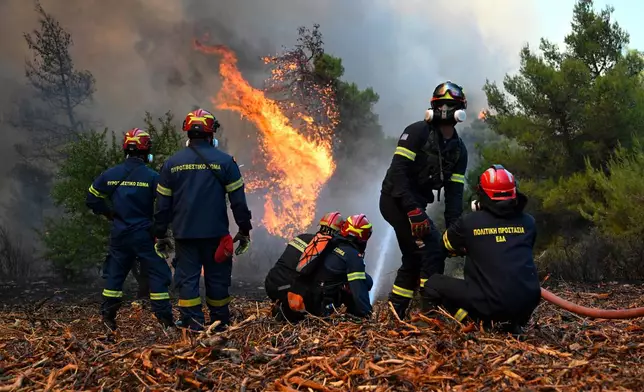 Firefighters operate during a wildfire near Porto Germeno, northwest of Athens, Greece, Sunday, Aug. 2, 2026. (AP Photo/Michael Varaklas)