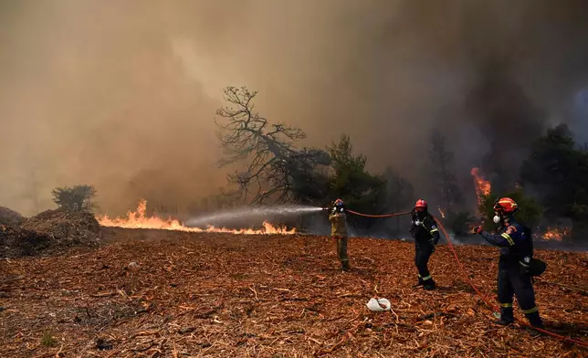 Firefighters operate during a wildfire near Porto Germeno, northwest of Athens, Greece, Sunday, Aug. 2, 2026. (AP Photo/Michael Varaklas)