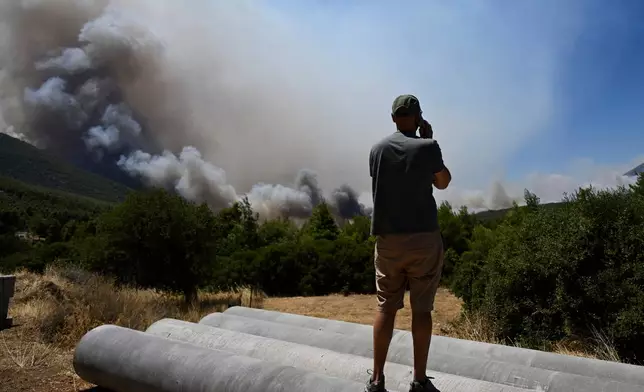 Smoke billows from a wildfire approaching Krio Pigadi near Porto Germeno, northwest of Athens, Greece, Saturday, Aug. 1, 2026. (AP Photo/Michael Varaklas)