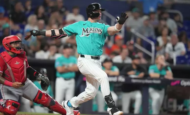 Miami Marlins' Griffin Conine, right, follows through on a two run home run during the fifth inning of a baseball game against the Los Angeles Angels, Sunday, Aug. 9, 2026, in Miami. (AP Photo/Lynne Sladky)