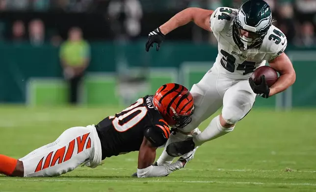 Philadelphia Eagles running back Carson Steele (34) is stopped by Cincinnati Bengals defensive back Tacario Davis (20) during the first half of a preseason NFL football game Friday, Aug. 28, 2026, in Philadelphia. (AP Photo/Matt Rourke)