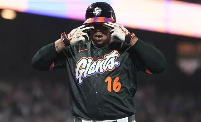 San Francisco Giants' Rafael Devers, gestures after hitting a home run against the Cincinnati Reds during the fifth inning of a baseball game Tuesday, Aug. 25, 2026, in San Francisco. (AP Photo/Tony Avelar)
