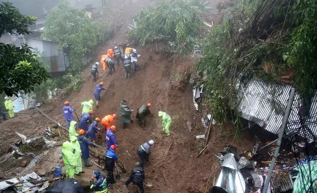 Rescuers conduct search and rescue operations for missing residents a day after several houses were buried from a landslide due to heavy monsoon rains in Guisad Surong, Baguio City, northern Philippines, Monday, Aug. 10, 2026. (AP Photo/Harley Palangchao)