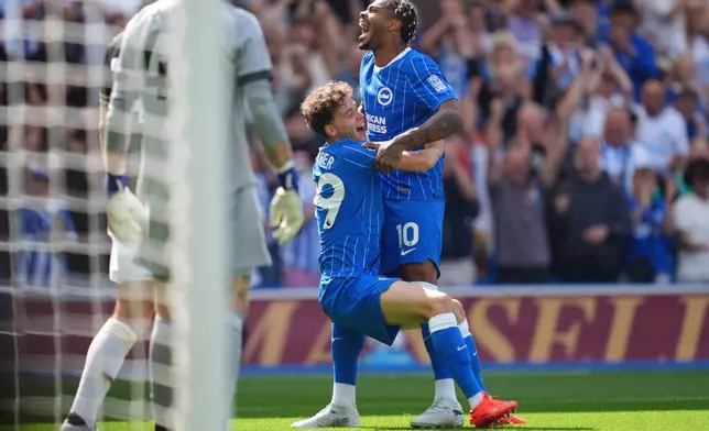 Brighton and Hove Albion's Maxim De Cuyper and Georginio Rutter celebrate their side's first goal of the game during the English Premier League soccer match between Brighton and Hove Albion and Aston Villa, in Brighton and Hove, England, Sunday Aug. 23, 2026. (Adam Davy/PA via AP)