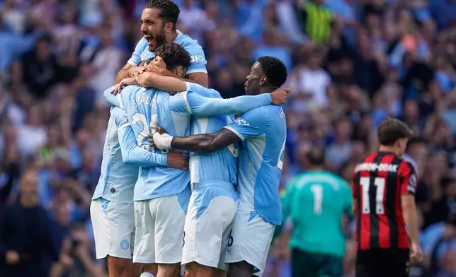 Manchester City's Josko Gvardiol (24) celebrates with teammates after scoring his side's second goal during the English Premier League soccer match between Manchester City and Bournemouth in Manchester, England, Sunday, Aug. 23, 2026. (AP Photo/Dave Thompson)