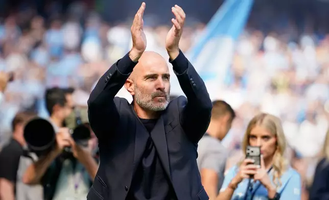 Manchester City's head coach Enzo Maresca greets fans ahead of the English Premier League soccer match between Manchester City and Bournemouth in Manchester, England, Sunday, Aug. 23, 2026. (AP Photo/Dave Thompson)