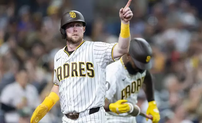 Jake Cronenworth celebrates after scoring off a single by Jackson Merrill in the sixth inning of a baseball game against the Minessota Twins Saturday, Aug. 22, 2026, in San Diego, Calif. (AP Photo/Karl Anderson)