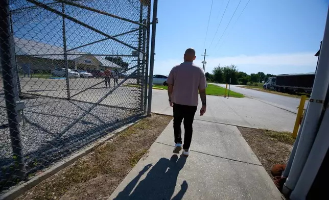 Army Staff Sgt. Alexis Jaramillo walks to the entrance of the South Louisiana ICE Processing Center to visit his wife, Maisa Lopes Eliaser, a Brazilian national who is being detained by ICE, in Basile, La., Sunday, Aug. 2, 2026. (AP Photo/Joseph Vidrine)