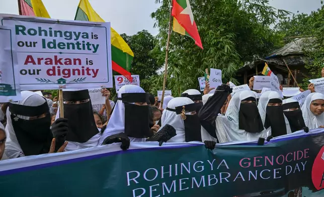 Rohingyas shout slogans during an event at a refugee camp in Cox's Bazar, Bangladesh, Tuesday, Aug. 25, 2026, marking the anniversary of the their exodus. (AP Photo/Abdul Goni)