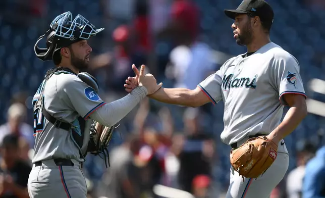 Miami Marlins relief pitcher Michael Petersen, right, celebrates with catcher Joe Mack, left, after a baseball game against the Washington Nationals, Sunday, Aug. 30, 2026, in Washington. (AP Photo/Nick Wass)