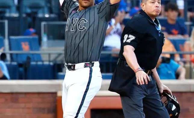 New York Mets' Juan Soto reacts after scoring during the fifth inning of a baseball game against the Houston Astros, Saturday, Aug. 29, 2026, in New York. (AP Photo/Noah K. Murray)