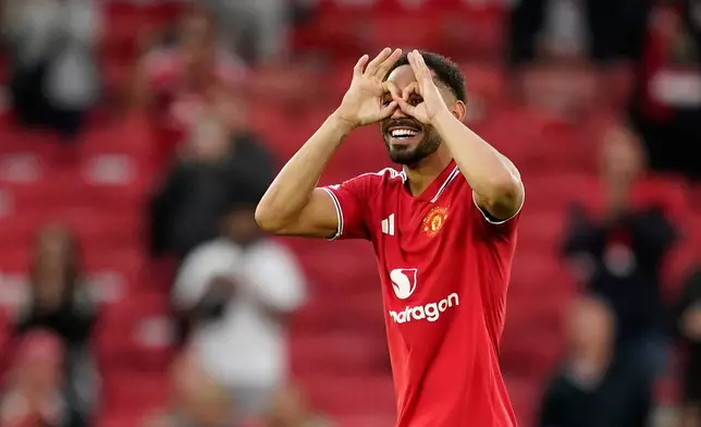 Manchester United's Matheus Cunha celebrates after his team defeated Ipswich Town in an English Premier League soccer match in Manchester, England, Sunday, Aug. 30, 2026. (AP Photo/Dave Thompson)