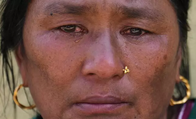 Sunmaya Tamang waits outside an army camp for the news of her missing relatives following flash flooding in Nepal's Nuwakot district, Friday, Aug. 28, 2026. (AP Photo/Rajesh Kumar Singh)