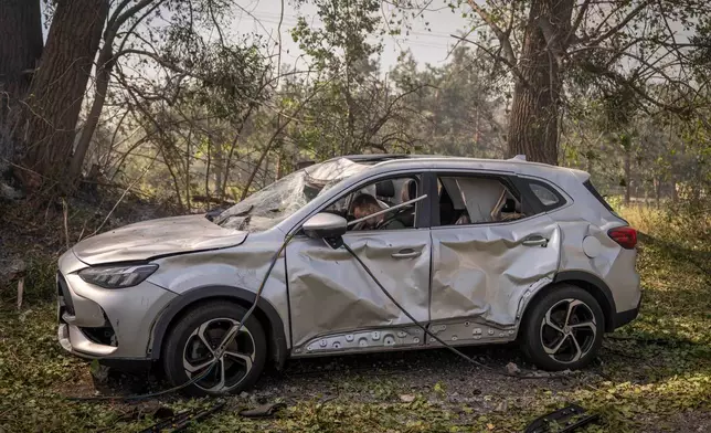 The body of driver, after a Russian attack struck a warehouse, followed by an explosion, in the village of Myla, Kyiv region, Ukraine, Saturday, Aug. 29, 2026. (AP Photo/Dan Bashakov)