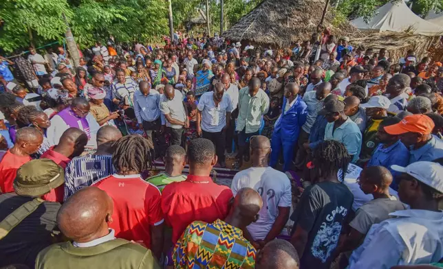 Mourners gather as the casket of 29 years old Penina Zawadi, who died from complications while giving birth, is lowered into her grave during her funeral in Kilifi County, Kenya, Saturday, July 18, 2026. (AP Photo/Brian Wachira)