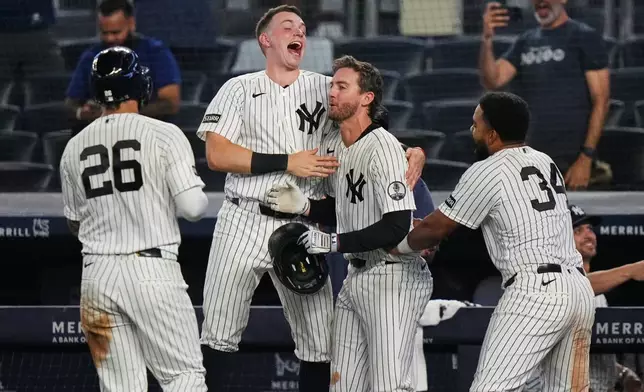 New York Yankees' Ryan McMahon, center, celebrates with Heliot Ramos, right, Ben Rice, second from left, and Luis García Jr. after a baseball game against the Atlanta Braves Saturday, Aug. 8, 2026, in New York. (AP Photo/Frank Franklin II)