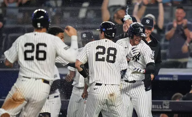 New York Yankees' Ryan McMahon, right, celebrates with teammates after a baseball game against the Atlanta Braves Saturday, Aug. 8, 2026, in New York. (AP Photo/Frank Franklin II)