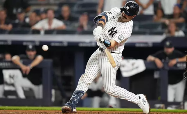 New York Yankees' Austin Wells hits an RBI double during the ninth inning of a baseball game against the Atlanta Braves Friday, Aug. 7, 2026, in New York. (AP Photo/Frank Franklin II)