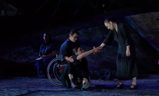 From left to right, Eirini Kourouvani, a wheelchair dancer, Evi Saoulidou and Lydia Fotopoulou perform during a dress rehearsal of Euripides' tragedy The Trojan Women, staged by the National Theatre of Greece, at the Ancient Theater of Epidaurus, Greece, on Thursday, July 30, 2026. (AP Photo/Petros Giannakouris)