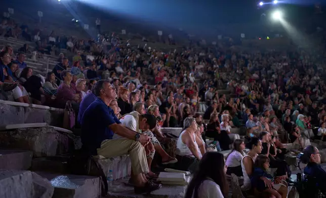 Audience members watch a performance of Euripides' tragedy The Trojan Women, staged by the National Theatre of Greece at the Ancient Theater of Epidaurus, Greece, on Sunday, Aug. 2, 2026. (AP Photo/Petros Giannakouris)