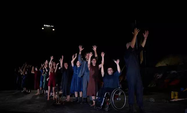 Cast members with and without disabilities acknowledge the audience with a curtain call after a performance of Euripides' tragedy The Trojan Women, staged by the National Theatre of Greece at the Ancient Theater of Epidaurus, Greece, on Sunday, Aug. 2, 2026. (AP Photo/Petros Giannakouris)