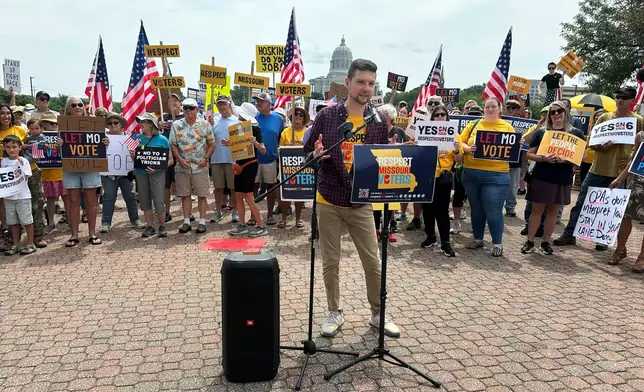 Benjamin Singer, co-founder of Respect Missouri Voters, leads a rally in support of a proposed constitutional amendment near the state Capitol in Jefferson City, Mo., Friday, Aug. 7, 2026. (AP Photo/David A. Lieb)
