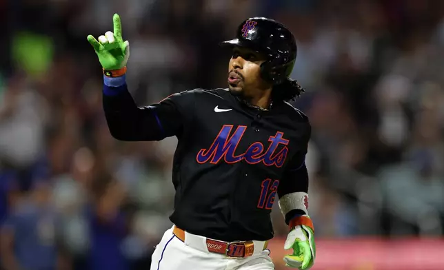 New York Mets' Francisco Lindor reacts after hitting a solo home run during the fifth inning of a baseball game against the Milwaukee Brewers, on Tuesday, Aug. 25, 2026, in New York. (AP Photo/Adam Hunger)